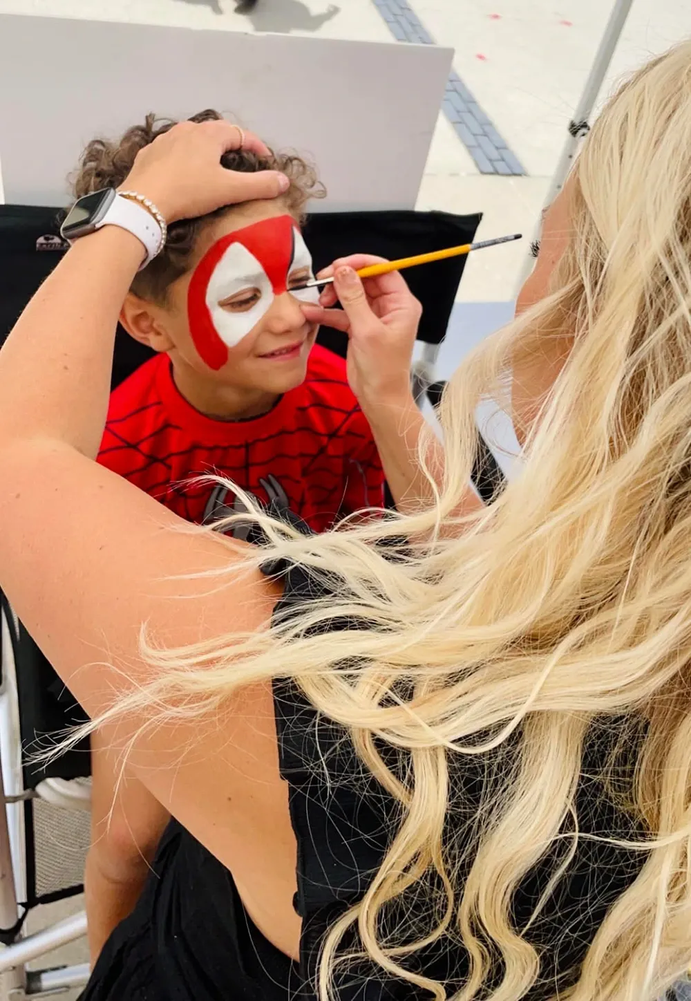 kid with spiderman face paint