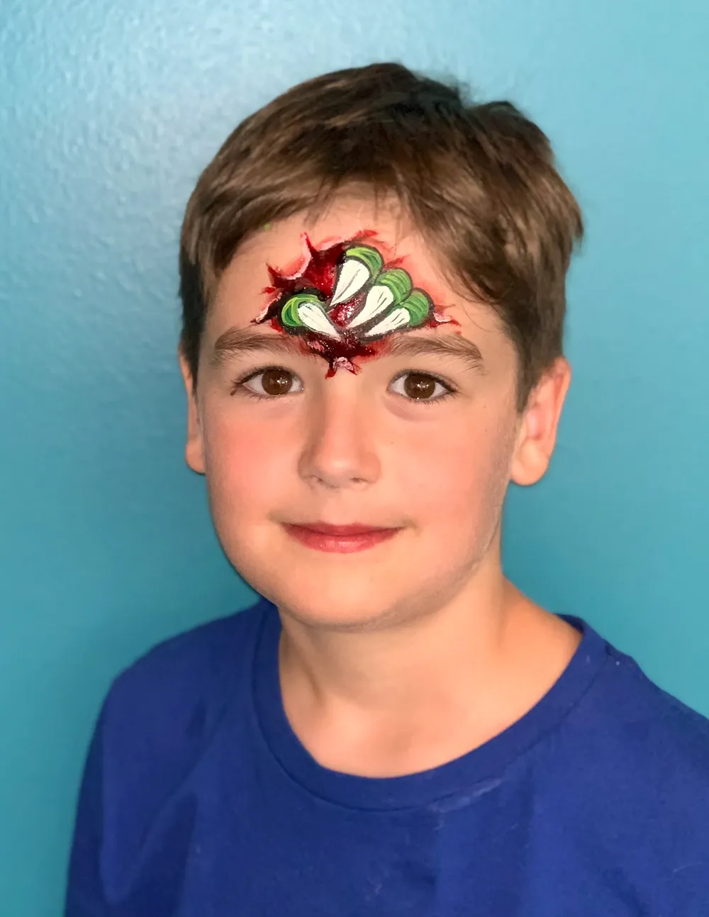 boy with monster claw face paint