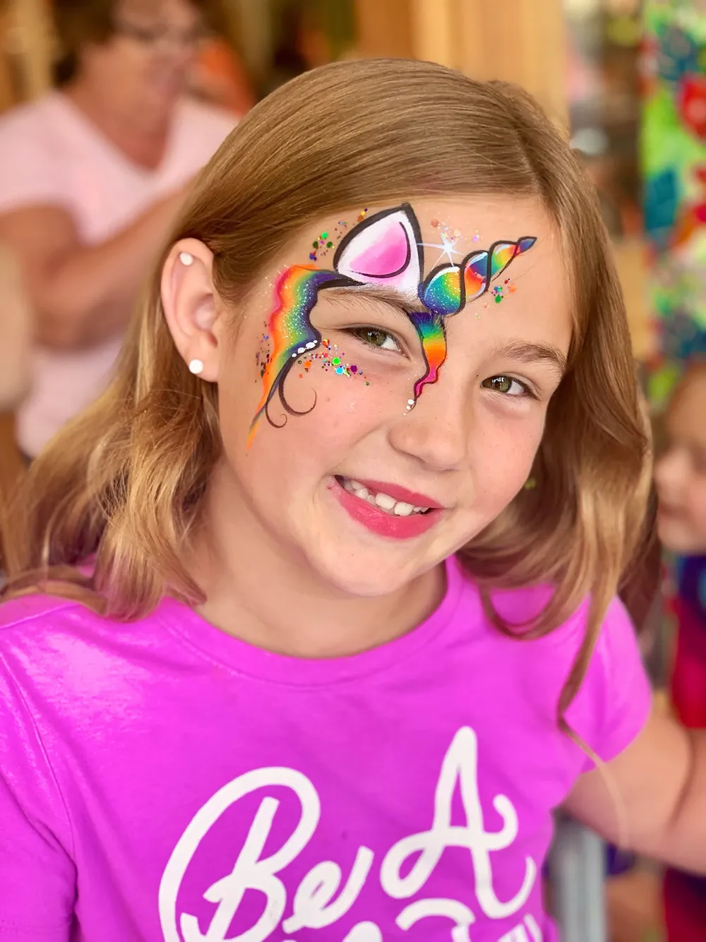 girl with rainbow unicorn face paint