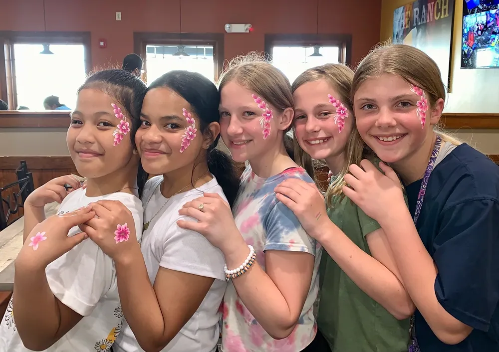 group of girls with flower face paint