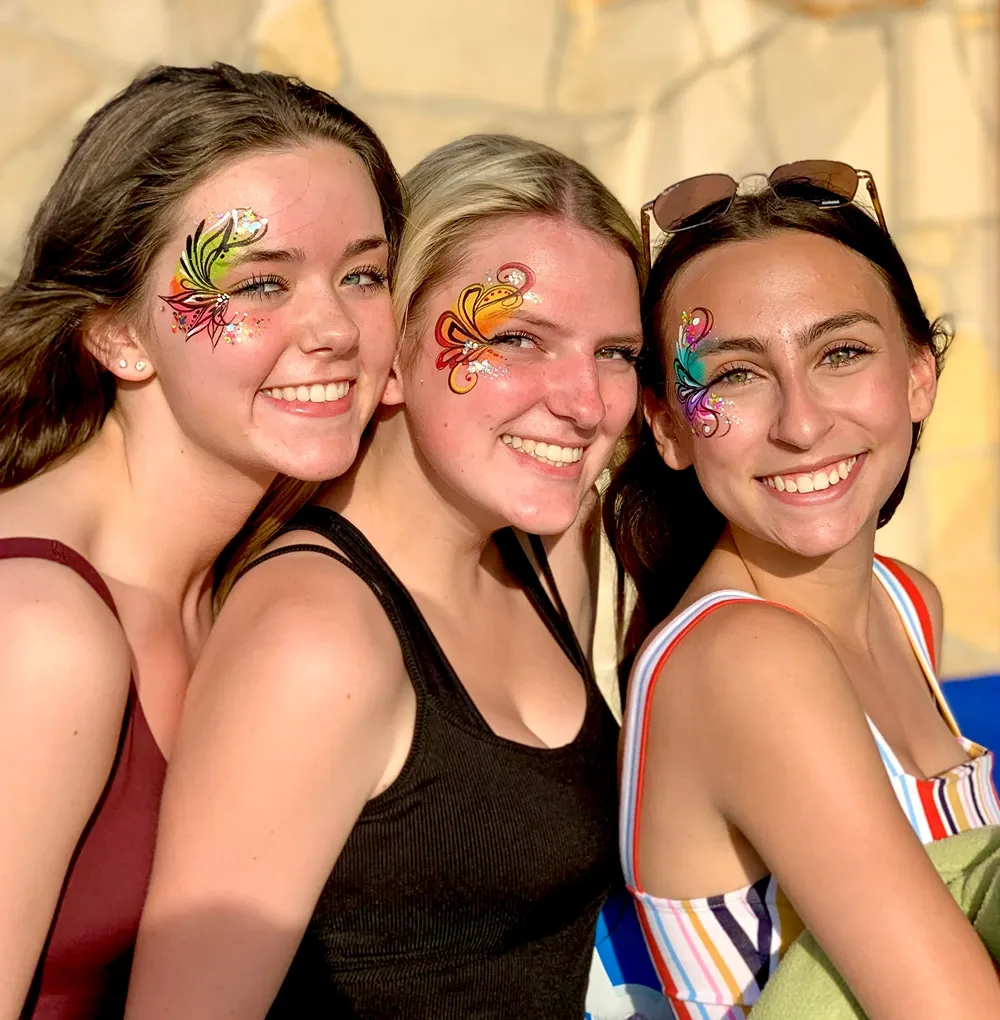 women with colorful flower face paint