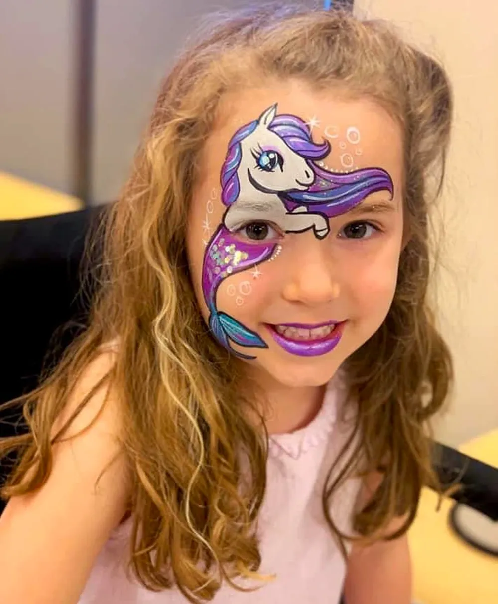 kid with unicorn mermaid face paint