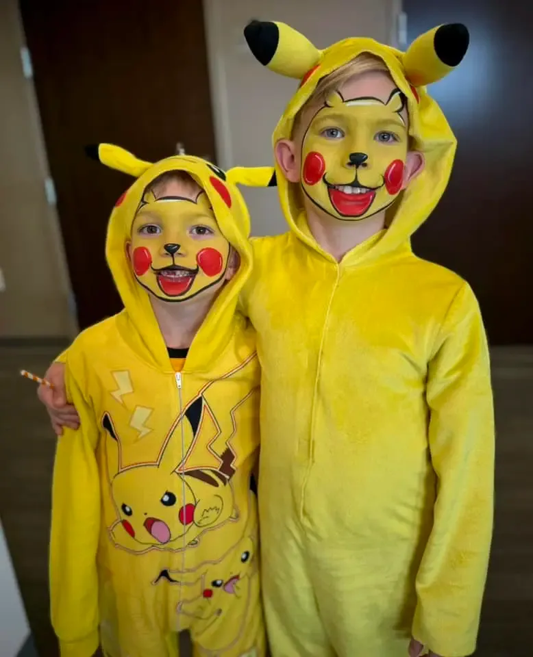two boys with pikachu full face paint