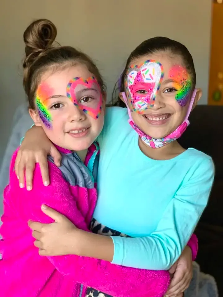 girls with rainbow heart face paint