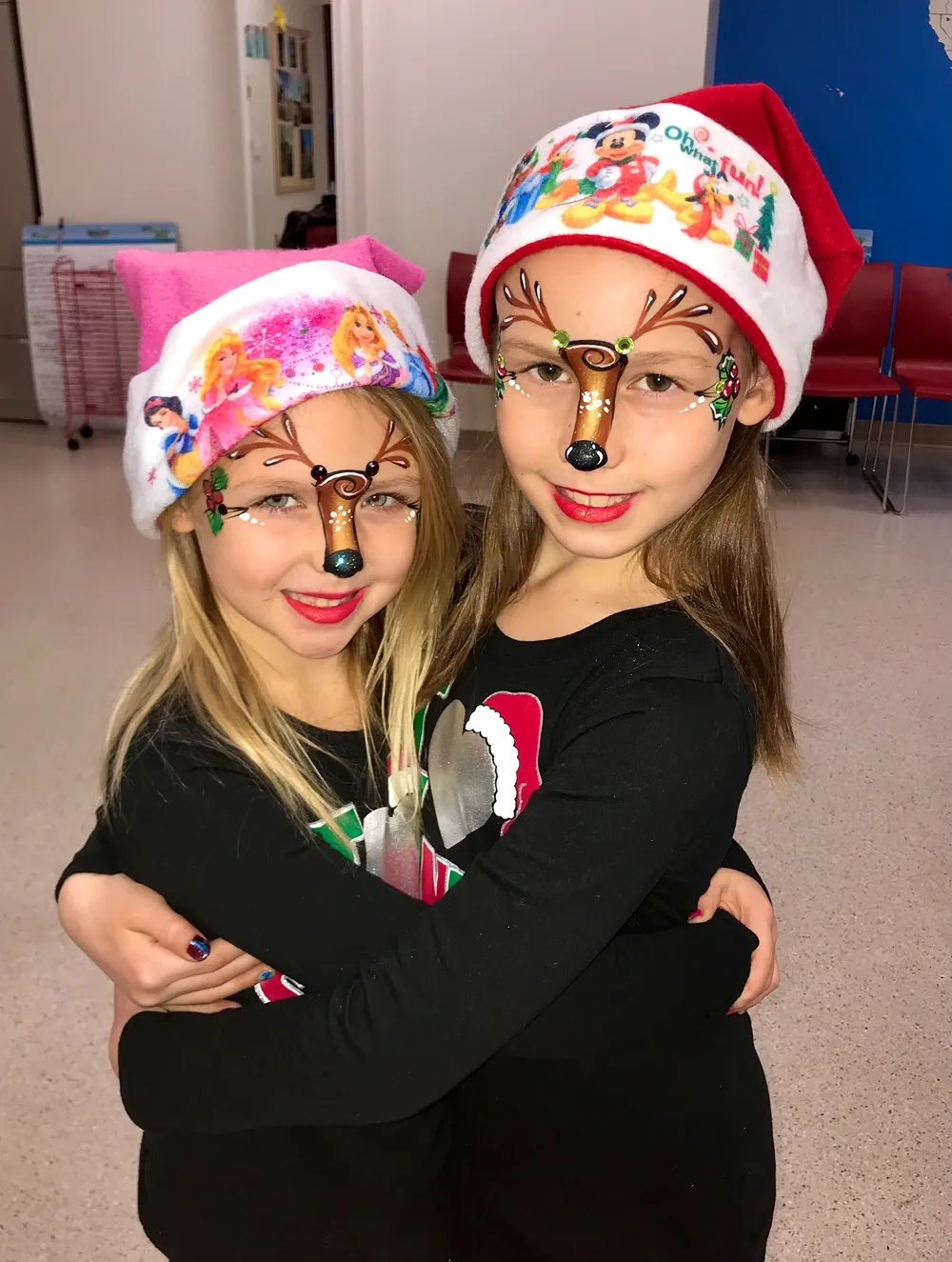 girls with christmas face paint reindeer
