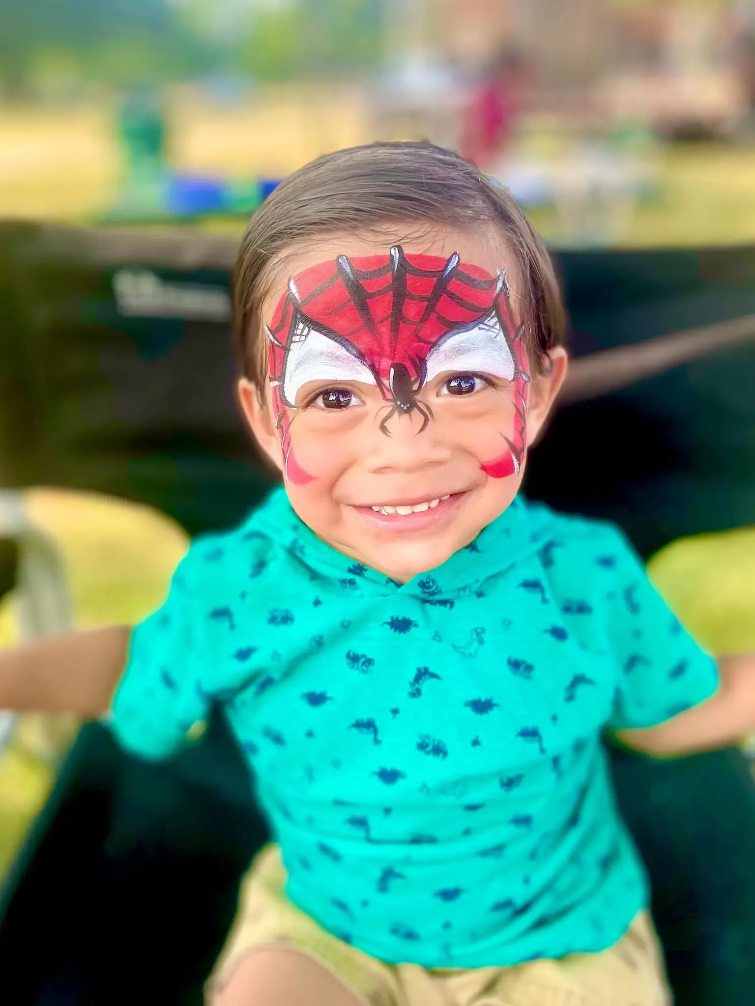 boy with spiderman face paint