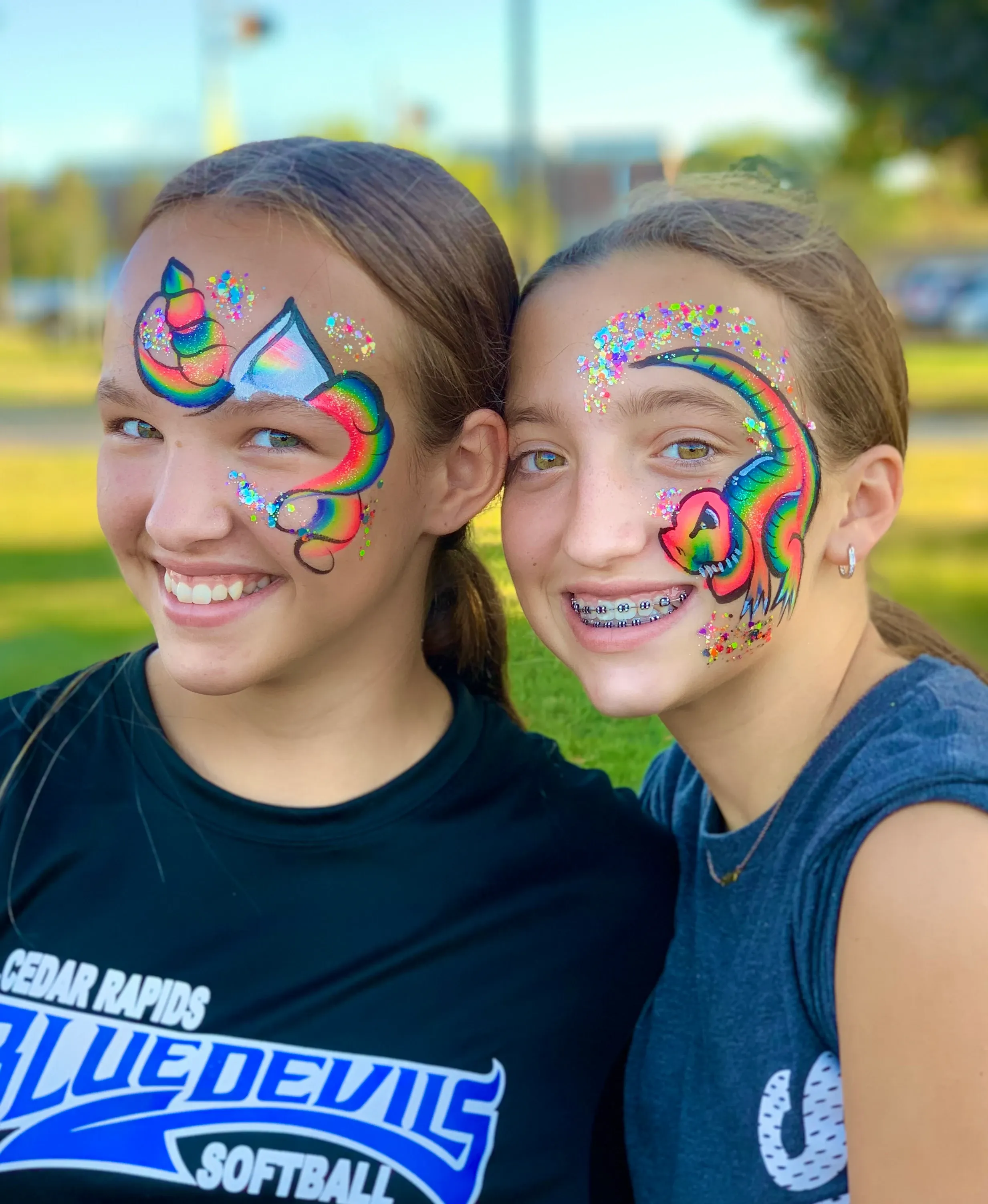 two girls with rainbow unicorn face paint