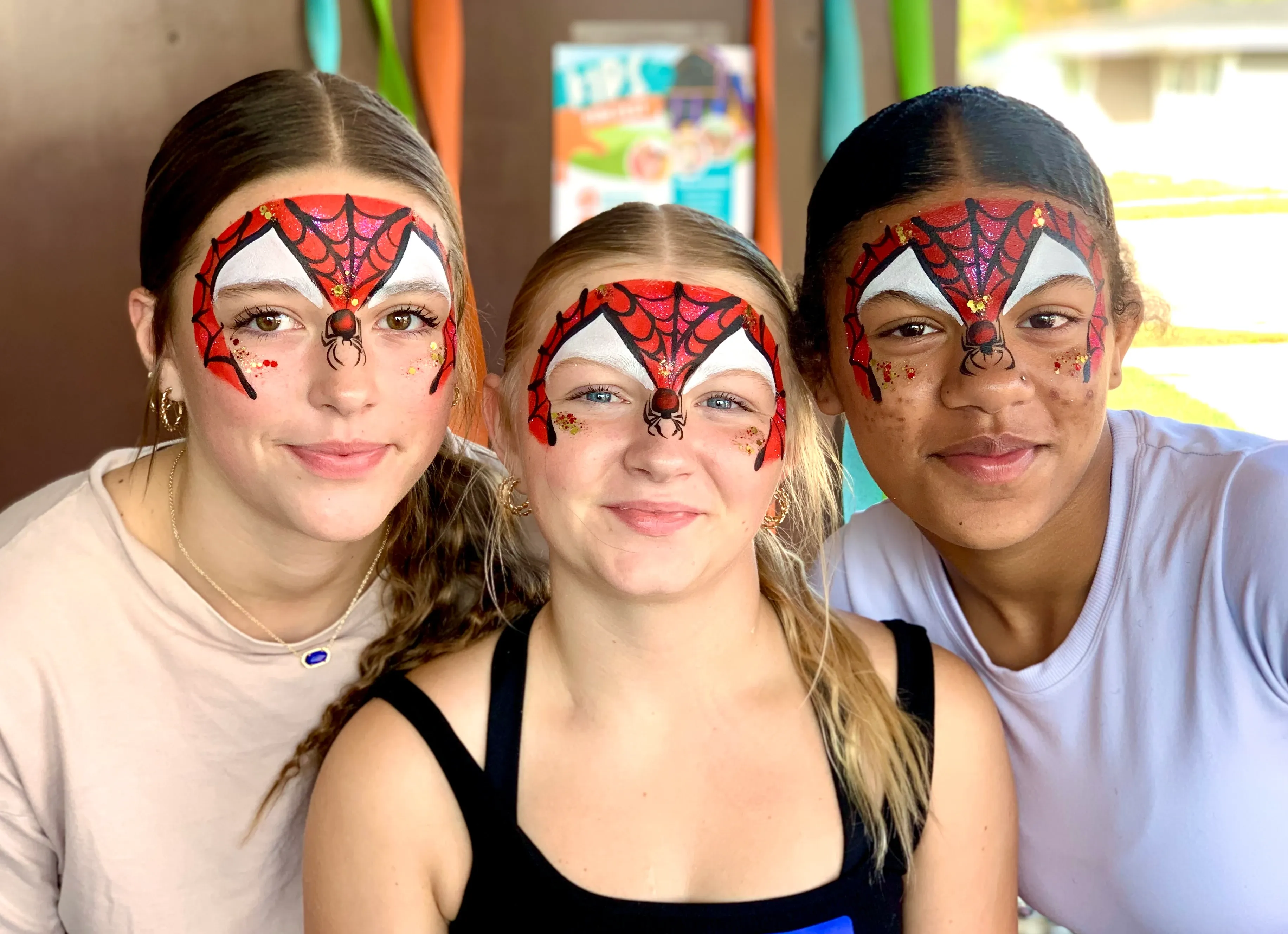 three girls with spiderman face paint