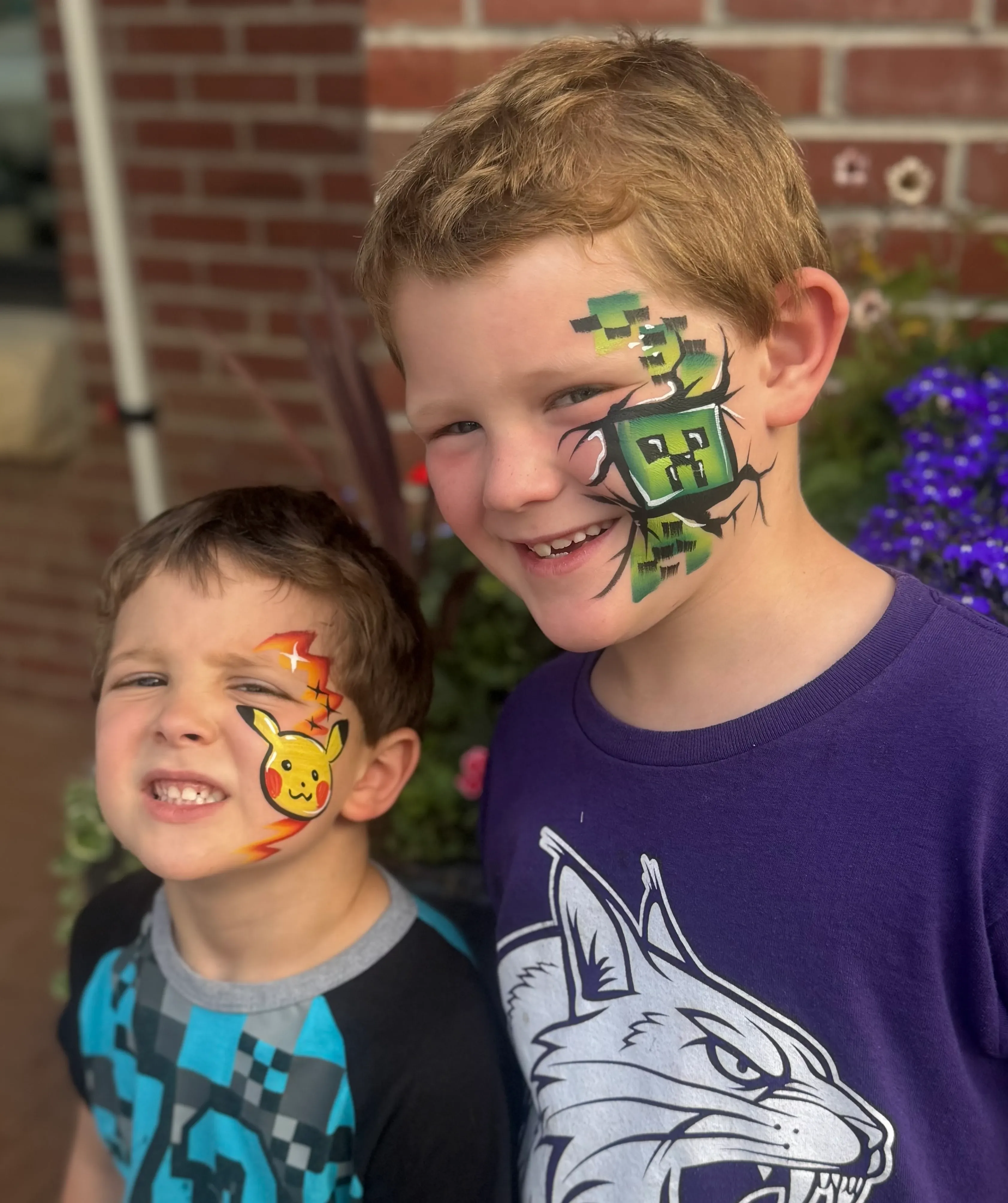 two boys with pokemon and roblox face paint