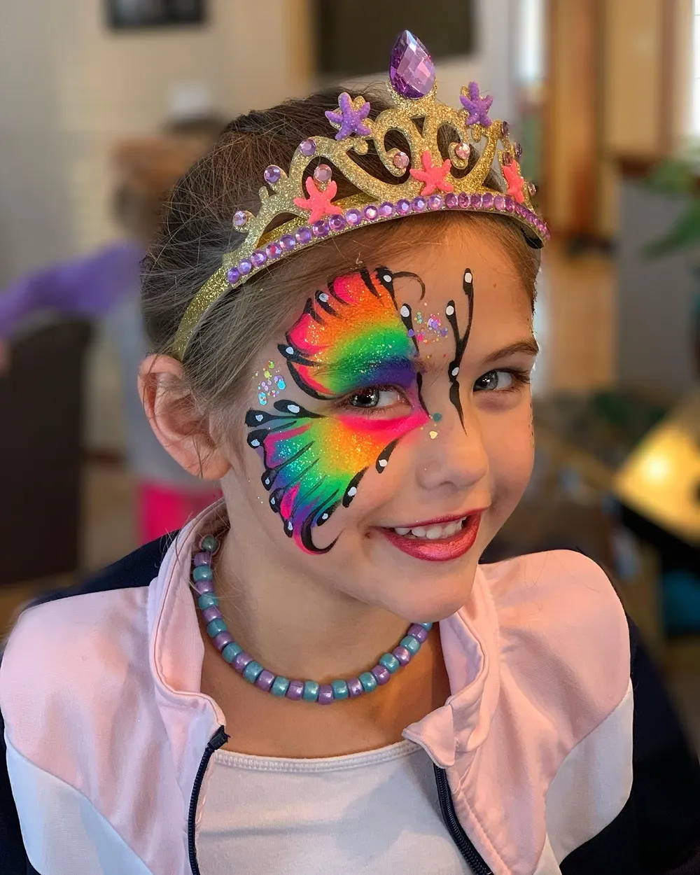 girl with rainbow butterfly face paint